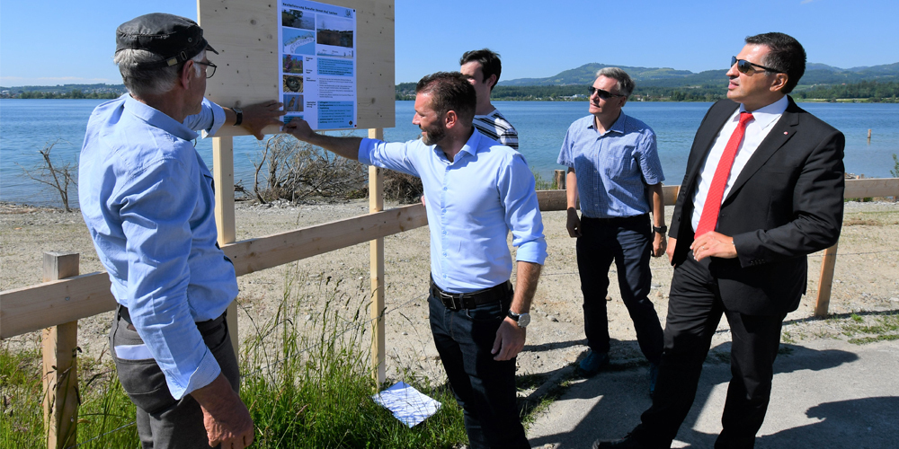 Projektleiter Thomas Oesch, Genossenpräsident Marcel Städtler, verdeckt Andrej Koci, Hochschule Ost, Rapperswil, alt Genossenpräsident Alex Rauchenstein und Regierungsrat Sandro Patierno vor einer provisorischen Schautafel zum Projekt. Bild zvg