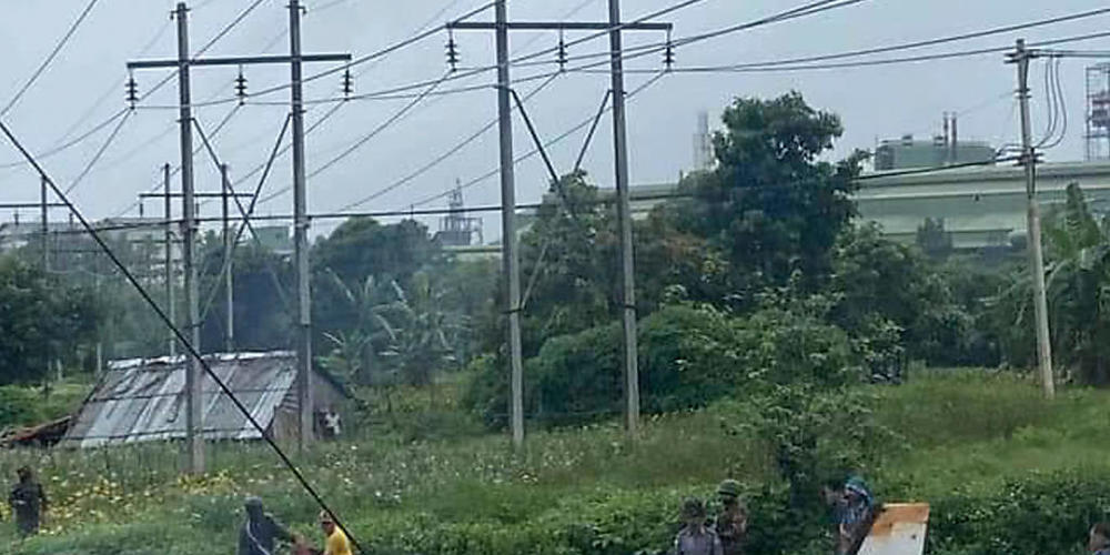 HANDOUT - Soldaten und Einheimische stehen neben dem Wrack einer Beechcraft 1900 der Myanmar Air Force, die  in Pyin Oo Lwin, Mandalay, Myanmar, abgestürzt ist. Zwölf der 14 Passagiere wurden getötet, wie die staatlichen Medien berichten. Foto: Un...