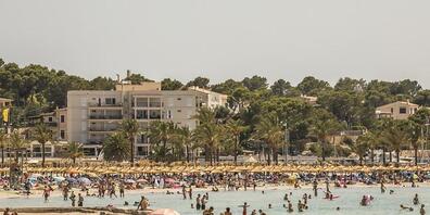 Badegäste genießen das gute Wetter am Strand von Arenal auf Mallorca. Aufgrund steigender Zahlen an Neuinfektionen wurde Spanien zum Corona-Hochinzidenzgebiet hochgestuft. Foto: John-Patrick Morarescu/ZUMA Press Wire/dpa