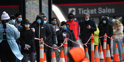 People are seen waiting in line at a pop-up Covid19 testing facility outside of the LaCrosse apartment block in Docklands, Melbourne, Sunday, July 25, 2021.  The LaCrosse Building at in Docklands has been listed as a tier 2 exposure site for all d...