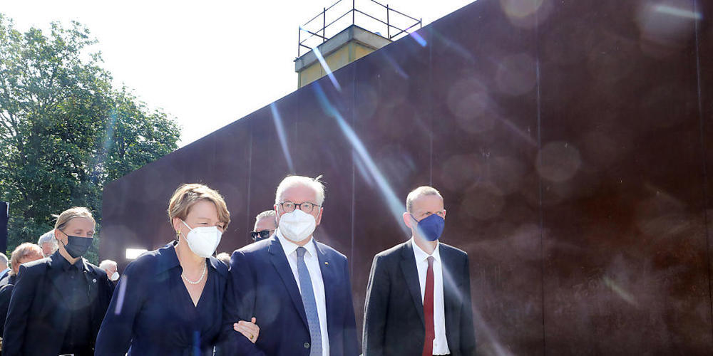 Bundespräsident Frank-Walter Steinmeier (M) und seine Frau Elke Büdenbender bei der zentralen Gedenkveranstaltung zum 60. Jahrestag des Baus der Berliner Mauer. Foto: Wolfgang Kumm/dpa