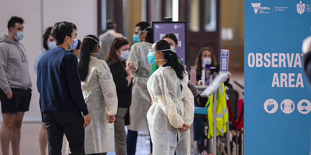 A health worker directs people into the 15-minute waiting area after receiving their vaccinations at the Royal Exhibition Building COVID19 Vaccination Hub in Melbourne, Thursday, September 2, 2021. Most of Victoria's tough coronavirus restrictions...