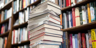 ARCHIV - Ein Stapel neuer Bücher liegt auf einem Verkaufstisch in einer Buchhandlung im Stadtteil Bornheim. Was sind die preisverdächtigsten Romane des Jahres? Der Börsenverein des Deutschen Buchhandels hat die sogenannte Longlist für den Deutsche...