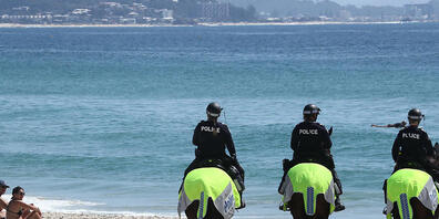 Police on horses are seen on Coolangatta beach on the New South Wales and Queensland border during an anti-lockdown protest in Coolangatta , QLD, Sunday, August 29, 2021. (AAP Image/Jason O'Brien) NO ARCHIVING
