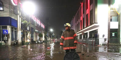 Ein Feuerwehrmann steht in einer überfluteten Straße in Ecatepec. Aufgrund starker Regenfälle am Montag kam es im Zentrum von Ecatepec im Bundesstaat Mexiko zu Überschwemmungen. Foto: El Universal/El Universal via ZUMA Press Wire/dpa