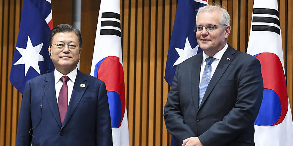 Australian Prime Minister Scott Morrison (right) and South Korean President Moon Jae-in witness a signing ceremony at Parliament House, Canberra, Monday, December 13, 2021. President Moon Jae-in is on a two-day offical visit to Australia.  (AAP Im...