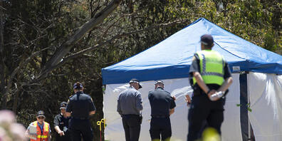 Worksafe Tasmania officers (left) inspect the jumping castle  at Hillcrest Primary School in Devonport, Tasmania, Thursday, December 16, 2021. Several children have suffered serious injuries in northwest Tasmania after falling about 10 metres from...
