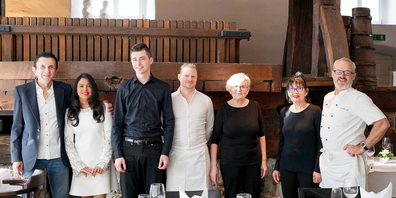 Das Team vor der Trotte aus Eichenholz: (v._l.) Fredi und Roshini Bloch-Nizam, Lukas Marhea, Roman Diethelm, Isaura Gomes, Do Ceu Gomes Maria und Bruno Schmucki. 