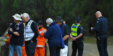 SES Personnel and Victorian Police officers are seen at a road block near the command post at Blair's Hut at Mount Disappointment in Victoria, Thursday, March 31, 2022. Police have found what they believe is the wreckage of a helicopter missing in...