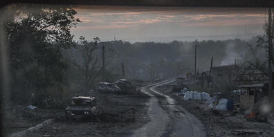 Während schwerer Kämpfe an der Front in Sjewjerodonezk in der Region Luhansk liegen ausgebrannte Autowracks am Rand eines Wegs. Foto: Oleksandr Ratushniak/AP/dpa