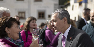 Bundespräsident Ignazio Cassis stösst an, beim Treffen mit der Bevölkerung nach der Bundesratssitzung "extra muros" auf dem Dorfplatz in Müstair.