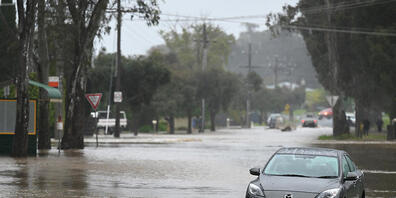 A partly submerged car is seen in flood water in Ascot, a northern suburb of Bendigo in Victoria, Thursday, October 13, 2022. Victoria is on alert for heavy rains and flooding, with a severe weather warning issued. (AAP Image/James Ross) NO ARCHIVING