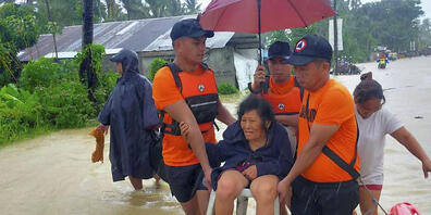 HANDOUT - Auf diesem von der philippinischen Küstenwache zur Verfügung gestellten Bild evakuieren Rettungskräfte Bewohner aus den durch den Tropensturm Nalgae verursachten Überschwemmungen in Hilongos, Provinz Leyte, Philippinen. Foto: Uncredited/...