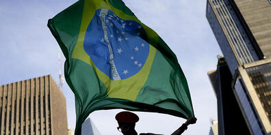 Eine Anhängerin des ehemaligen brasilianischen Präsidenten Lula da Silva, der erneut für das Präsidentenamt kandidiert, hält eine brasilianische Flagge. Foto: Matias Delacroix/AP/dpa