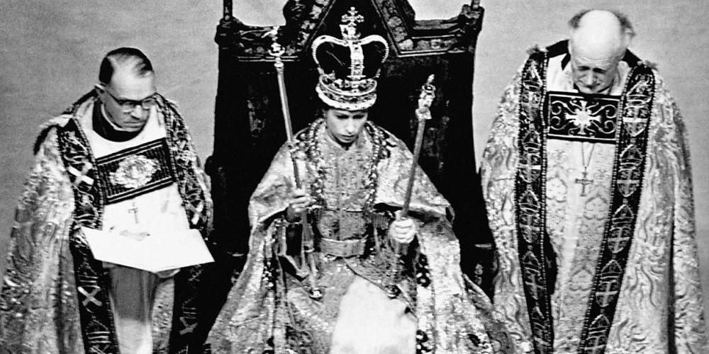Königin Elisabeth II. (M) trägt nach ihrer Krönung in der Westminster Abbey die Edwardskrone und trägt das Zepter und den Stab. Foto: -/PA Wire/dpa