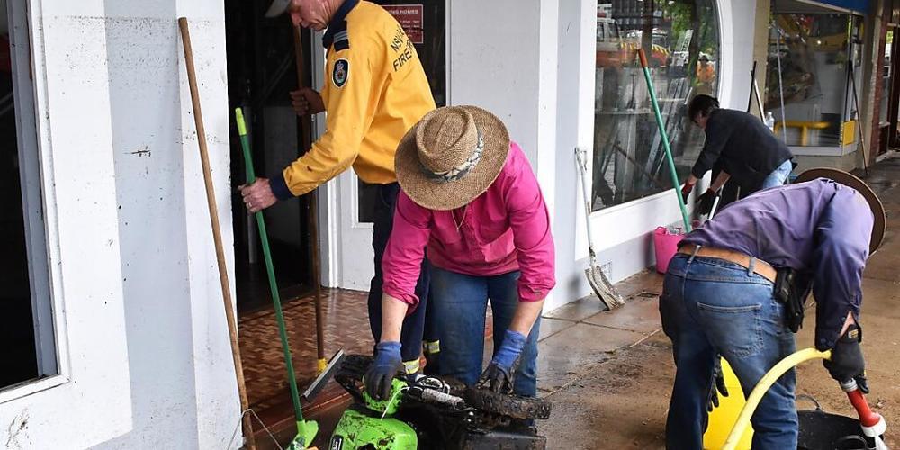 Volunteers and business owners remove debris from the central business district and clean up stock after flooding in the town of Molong, in the Central West region of New South Wales, Monday, November 14, 2022. (AAP Image/Murray McCloskey) NO ARCH...