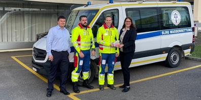 Nicolas Dietsche und Susanne Indermaur (SGKB) mit Kevin Berger (Kommunikationsverantwortlicher) und Jöel Rodi (Präsident SLRG Sektion Mittelrheintal) bei der Spendenübergabe vor dem Einsatzfahrzeug. 