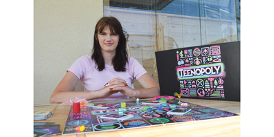 Sina Kaufmann hält ihr eigenes entwickeltes Spiel «Teenopoly» in der Hand.