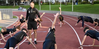 Morgendliches Athletiktraining auf der Rundbahn Ebnet in Herisau. Elias Valaulta leitet das Aufwärmprogramm der Sportschul-Gruppe.