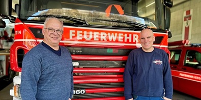 Beni Geel (Abteilungsleiter Technische Dienste) und Joe Gwerder (Gerätewart Feuerwehr) vor einem Tanklöschfahrzeug im Feuerwehrdepot.