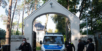 Polizeibeamte stehen im Rahmen einer Durchsuchung vor einem Grundstück in Kleinmachnow. Seit 6 Uhr morgens durchsuchen 300 Beamte der Polizei und Steuerfahndung insgesamt 18 Häuser, Wohnungen und Geschäftsräume in Berlin, Brandenburg und der Schwe...