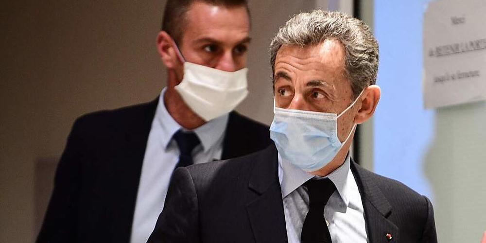 Nicolas Sarkozy (r), ehemaliger Präsident von Frankreich, verlässt nach einer Anhörung das Gerichtsgebäude. Foto: Martin Bureau/AFP/dpa