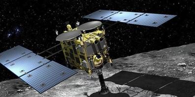 Hayabusa2 beim Sammeln von Gesteinsproben auf dem Asteroiden Ryugu. Die Arbeit ist getan, am Samstag wirft Hayabusa ihr Sammelkörbchen im Vorbeifliegen an der Erde ab, um gleich wieder zur nächsten Mission weiter zu ziehen. (JAXA)