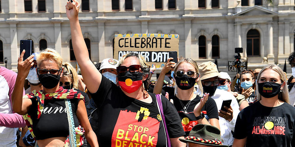 Protestors are seen during an Invasion Day rally in Brisbane, Tuesday, January 26, 2021. Australia Day 2021 has been marked by debates about changing the date or abolishing the holiday, Australia Day honours, and whether rallies should go ahead.(A...