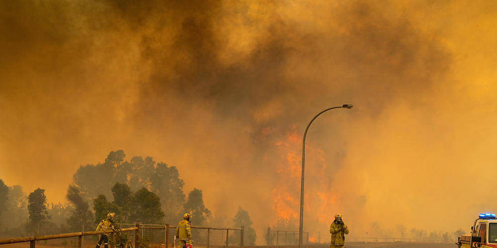 A supplied image obtained on Wednesday, February 3, 2021, of Fire fighters in Western Australia battling a blaze at Wooroloo, near Perth, Tuesday, February 02, 2021. More than 70 homes have been destroyed by a bushfire that's been burning out of c...