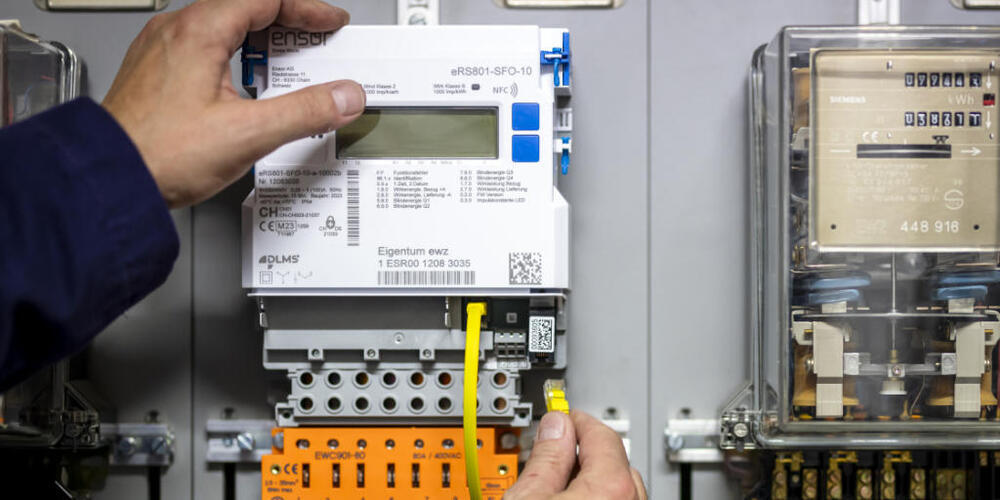 Ein Zählermonteur installiert einen Smart Meter-Stromzähler neben einem alten Stromzähler. (Symbolbild)