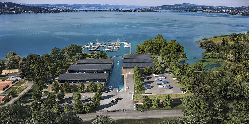 Die Visualisierung des neuen Hafens Spreitenbach zeigt den Segelhafen auf dem offenen See und hinten sechs neue Bootshallen mit PV-Anlagen auf dem Dach. Dazwischen wird eine neue Fussgängerbrücke erstellt. Auch die Parkplätze sind zum Teil neu angeordnet.